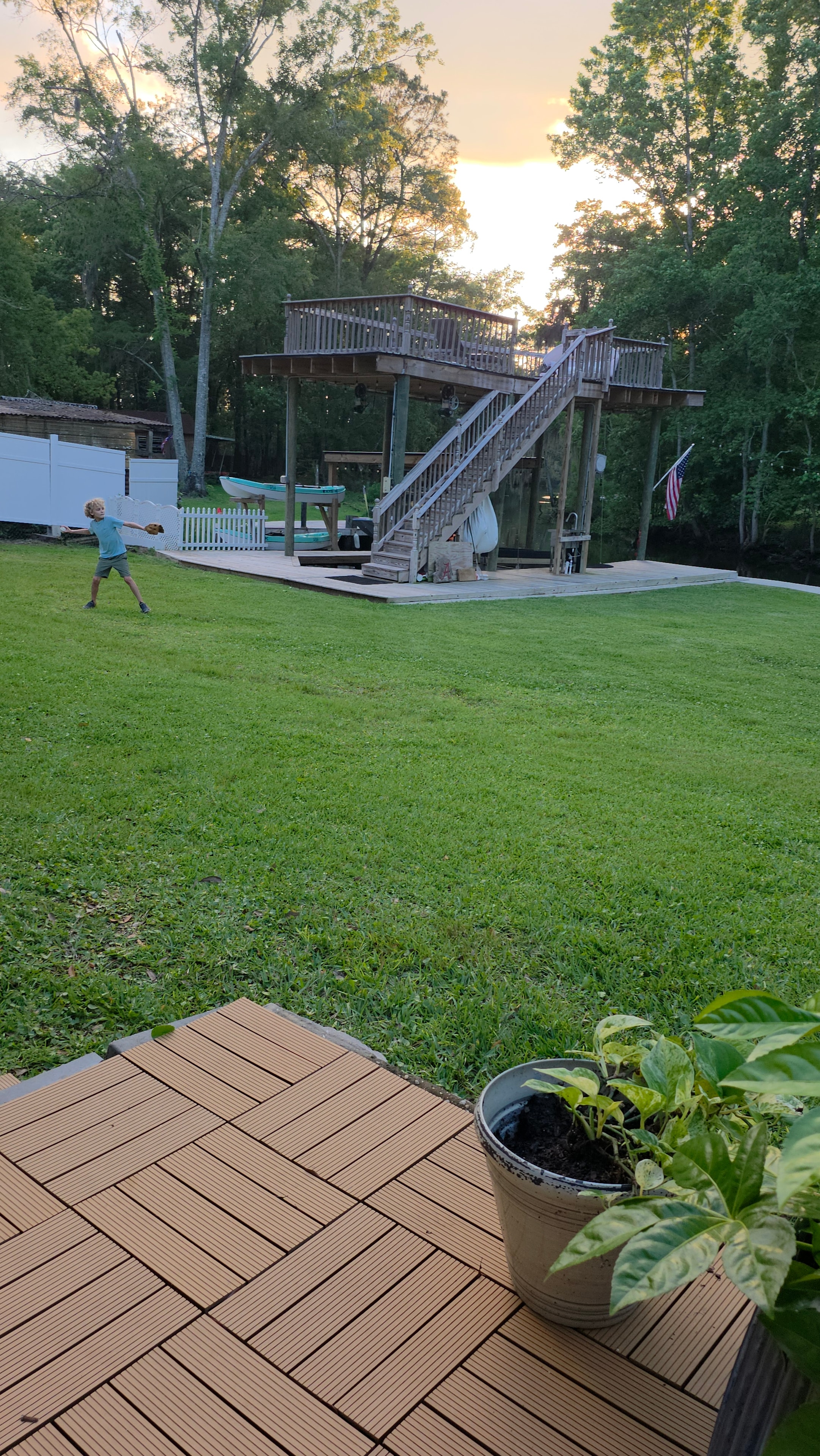 Eli practicing baseball in Granddaddy's backyard at sunset