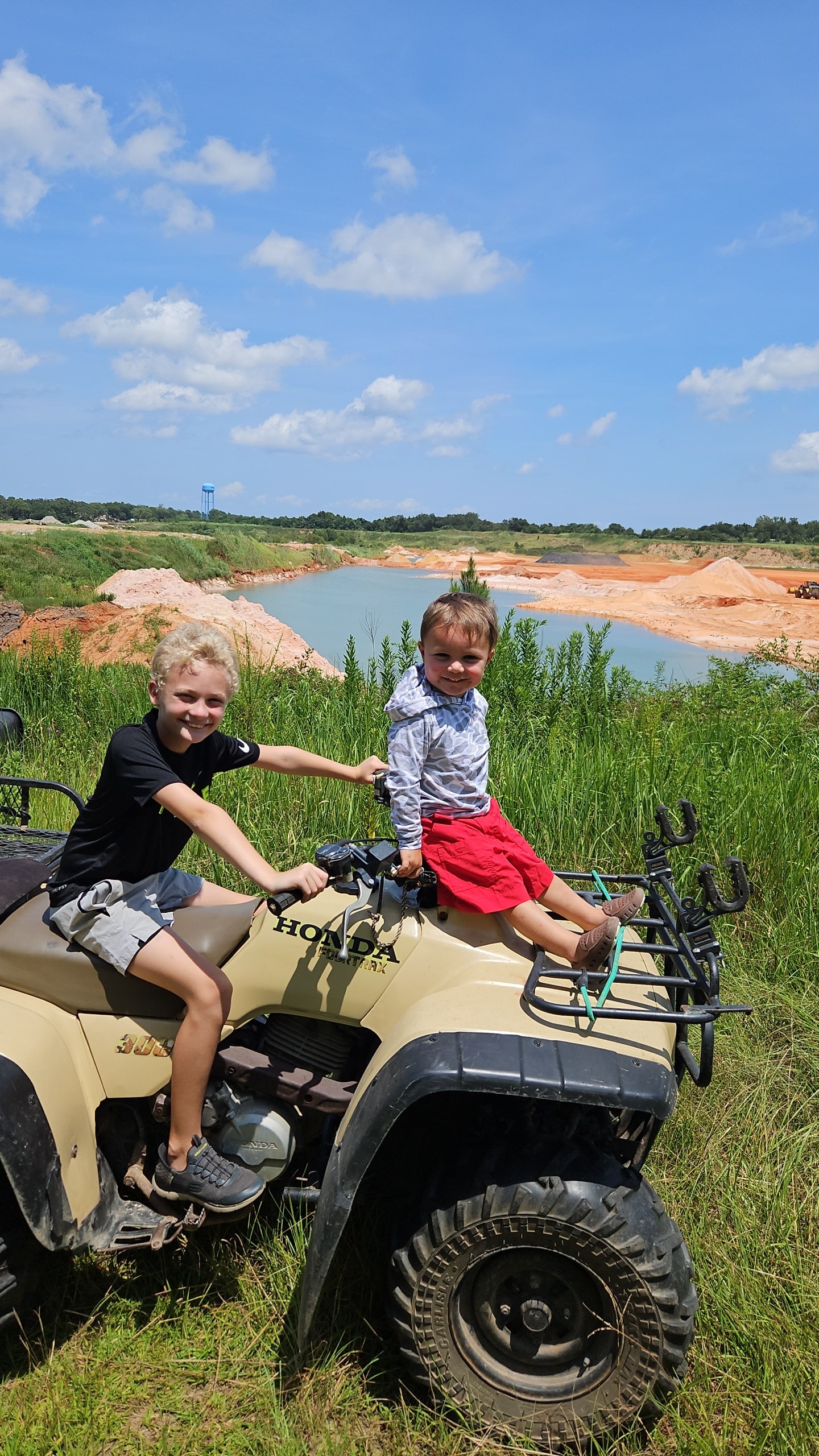 Eli and friend on a Honda ATV with a scenic outdoor backdrop